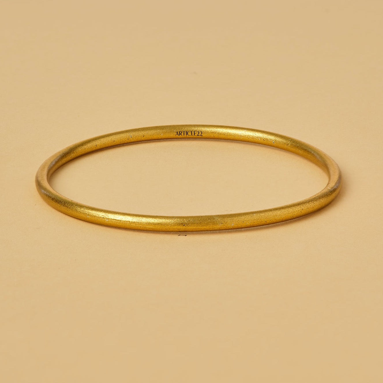 VIRTUOUS CIRCLE GOLD TONE SKINNY BANGLE
